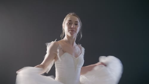 Elegant Ballerina Dancing in White Dress