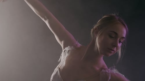 Elegant Woman Dances Gracefully in Studio