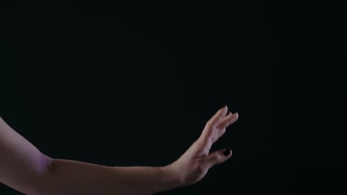 Ballerina Dancing on Stage or Dark Classroom Studio, of Only Hands with Magic Light on Background