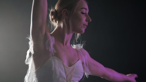 Graceful Ballerina Posing with Purple Lighting