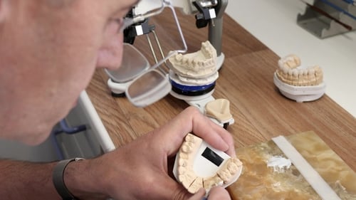 Dentist Repairing Teeth Mold with Dental Tool