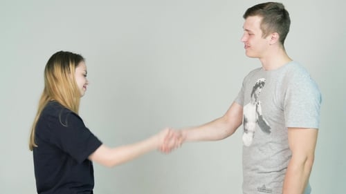 Young Adults Shake Hands in Bright Studio