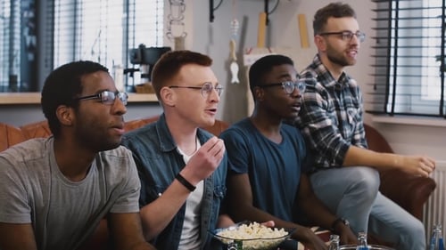 Friends Watch Event on Couch, React with Excitement