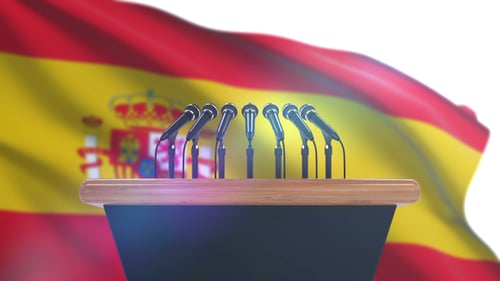 Spanish Flag and Podium with Microphones for a Press Conference