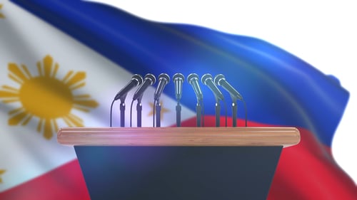 Waving Philippine Flag Behind Podium With Multiple Microphones
