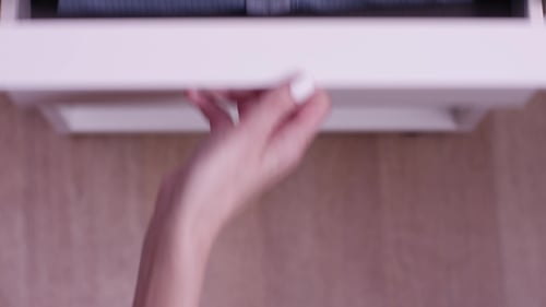 Female Hand Opens White Closet or Locker with Blue Shirt. Blue Expensive Shirt in Blue Stripes