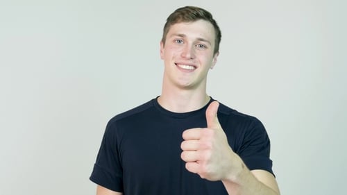 Young Man Gives Thumbs Up of Approval