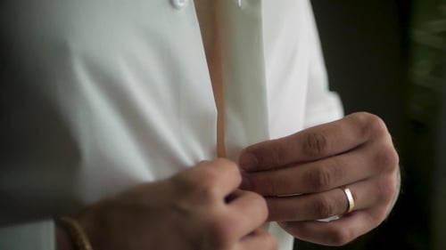 Groom Prepares for Wedding, Buttoning Shirt