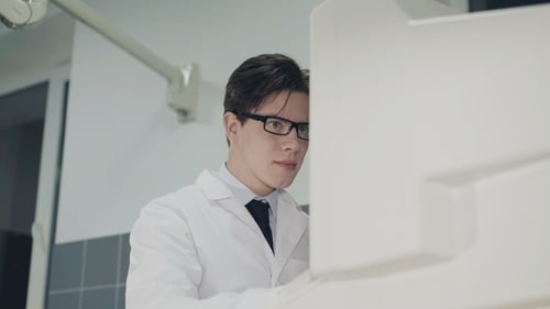 Two Medical Professionals Operate Medical Equipment