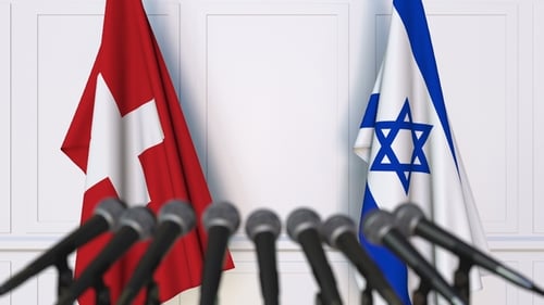Flags of Switzerland and Israel at a Press Conference