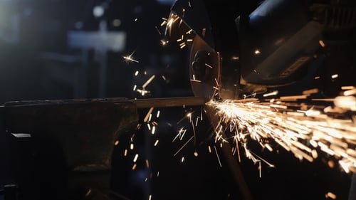 Worker Grinding Metal Construction with a Circular Saw