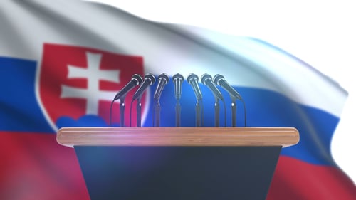 Press Conference Podium with Microphones and Slovakia Flag Background