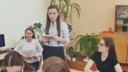 Teacher Reads to Her Class in School