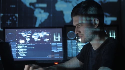 Man working on laptop with world map background