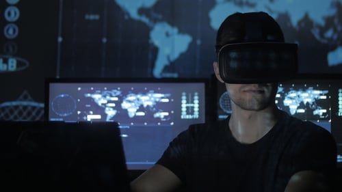Man Using VR Headset in Dark Tech Environment