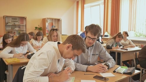 Russian School. Pupils Write a Control Exam in Their Notebooks.
