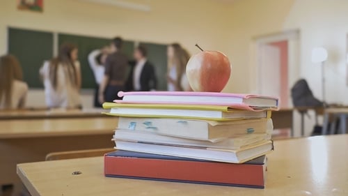 School Break in the Classroom. Books with Apple Are on the Table. School Theme.