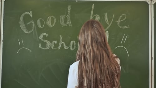 Girl Schoolgirl Writes on the Blackboard Phrase - Good Bye School. Farewell To the School.