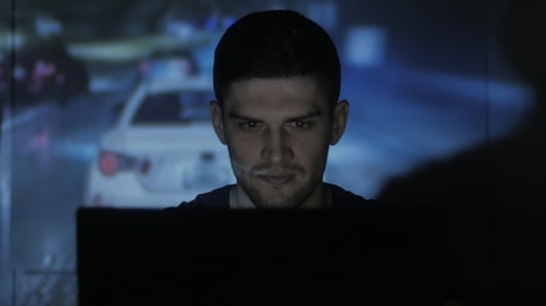 of Student Plays in a Street Racing Simulator with Laptop in Dark Room Double Exposure of the Game