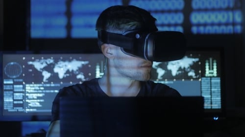 Man using VR Headset and working on computer