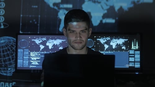 Man Working at Computer in Dark Room