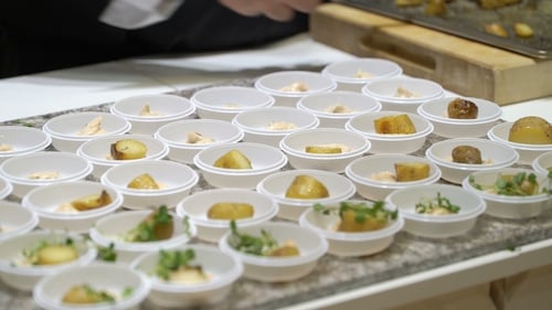 Chef Preparing Small Appetizer Bowls in Kitchen