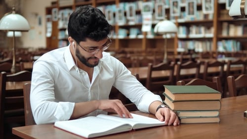 Young Adult Studying in a Library, Smiling