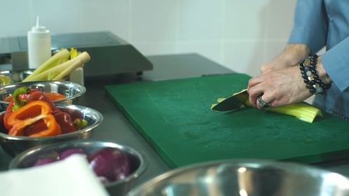 Chef Slicing Celery in Commercial Kitchen