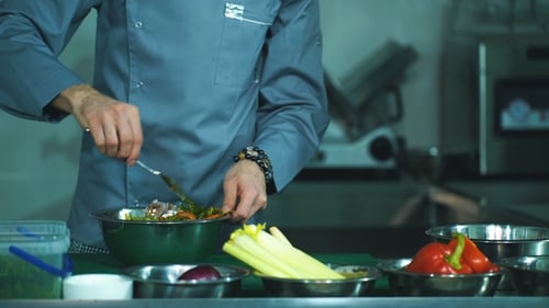 Chef Prepares Fresh Salad in Restaurant Kitchen
