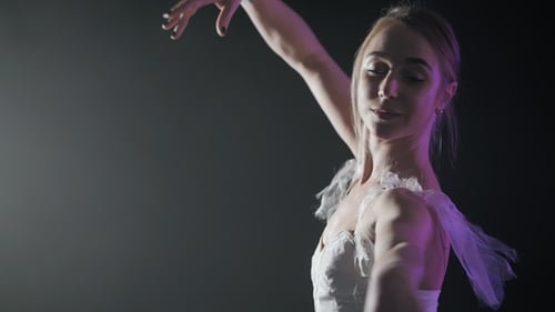Ballet Dancer in White Tutu Performing Arm Movements