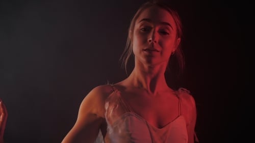 Elegant Woman Dancing Sensually in Red Light