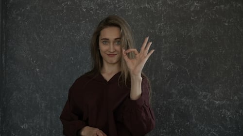 Woman Gesturing with her Hand and Smiling