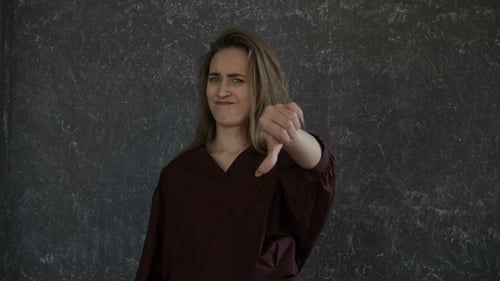 Young Woman Gives Thumbs Up and Thumbs Down