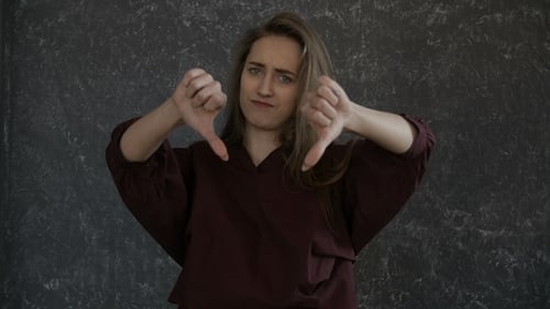 Woman Gives Thumbs Up and Thumbs Down Gestures