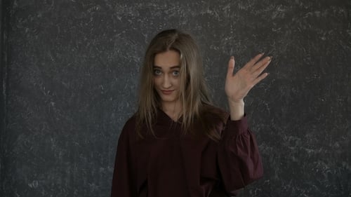 Blond Haired Woman Gesturing in Studio