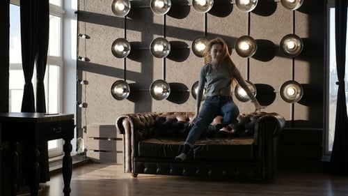 Woman relaxes on a couch in a modern home