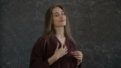 Smiling Woman Posing Elegantly in Indoor Studio