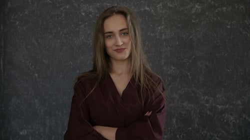 Confident Woman Posing Indoors With Arms Crossed