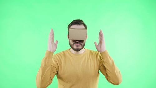Man in Vr Glasses Enjoy on the Green Background