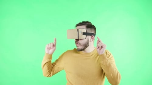Man in Vr Glasses Enjoy on the Green Background