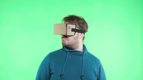 Man in Vr Glasses Enjoy on the Green Background