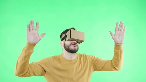 Young Man Exploring Virtual Reality on Green Screen