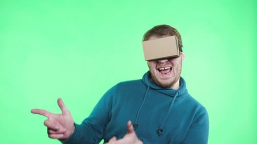 Man in Vr Glasses Enjoy on the Green Background