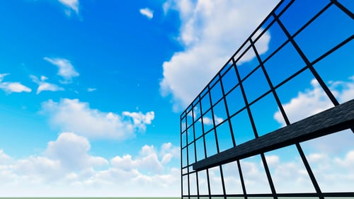 Sky and Clouds Reflecting Over Building