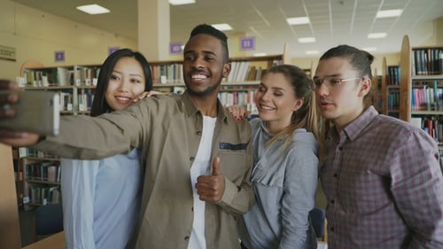 Friendly Students Take Selfie in University Library