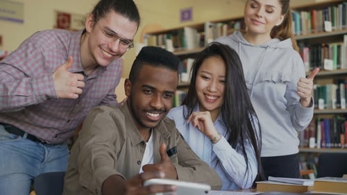 Happy Students Take Selfie in Library