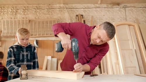 Man and Child Woodworking in Shop