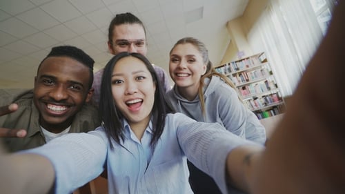 Point of View of Asian Girl Holding Smartphone Taking Selfie Photos with Cheerful Classmates