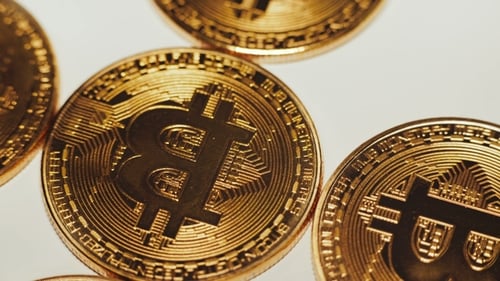 Cryptocurrency, Golden Bitcoins Rotating on the White Background