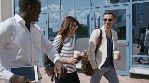 Cheerful Colleagues Walking and Talking in City